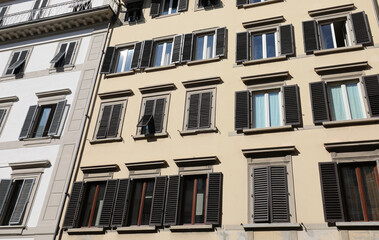 characteristic wooden balconies at the windows with partial opening building in the historic city...
