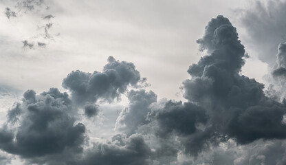 A dramatic and moody sky filled with towering, dark storm clouds signaling an impending storm.