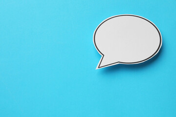 Blank speech bubble on light blue background, top view. Space for text