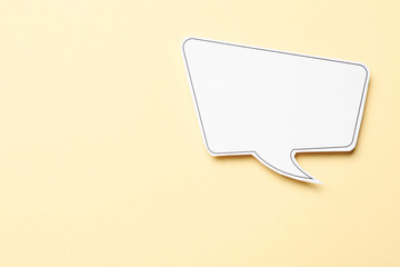 Blank speech bubble on beige background, top view. Space for text
