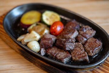 Diced meat steak served on plate with various vegetable