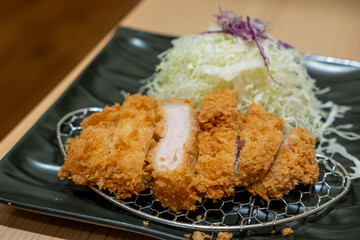 Tonkatsu, Fried Pork Loin Cutlet serve on plate with cabbage in restaurant