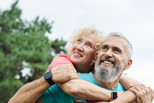 outdoor mature fitness woman man love active fun piggyback exercise healthy mid adult handsome confident fit sport adult couple mature exercising