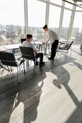 Two office workers working to together 