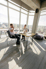 Two office workers working to together 