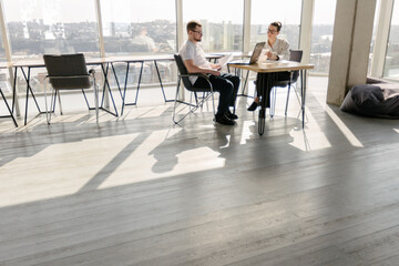 Two office workers working to together 