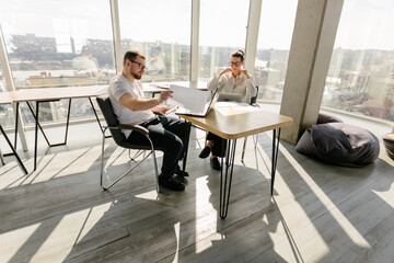 Two office workers working to together 