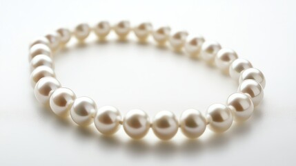 Fototapeta premium Elegant pearl bracelet on a light background.