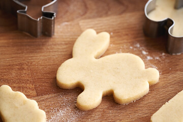 Bunny shape cut out from raw pastry dough - preparation of homemade Linzer Easter cookies