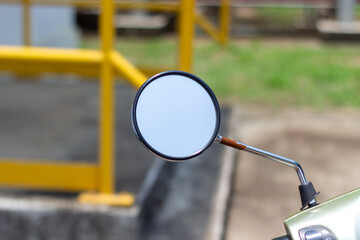 Close-up of a scooter round rearview mirror