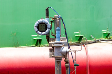 Close-up of industrial pressure transmitter with digital display showing measurement reading