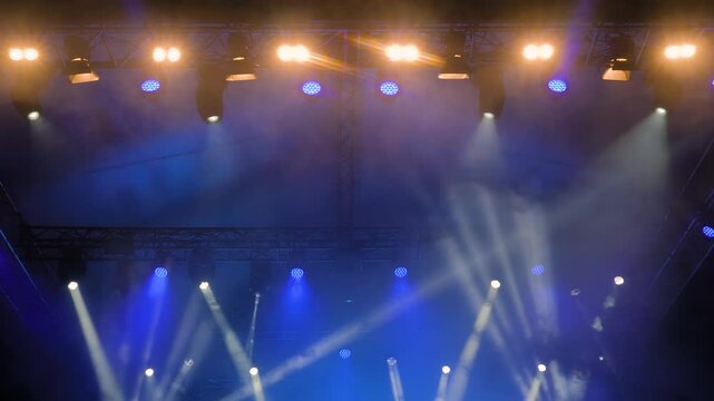 Colorful bright dynamic concert lighting for stage at nightclub. Illumination for entertainment, musical shows, parties, or performances at night. Nightlife, music, and entertainment concept