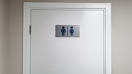 the door of a modern toilet in a public place with convenient and understandable designations
