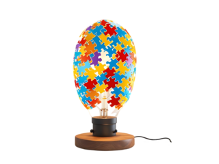 Colorful puzzle pieces forming a lightbulb shape on a wooden base, representing creativity and ideas.