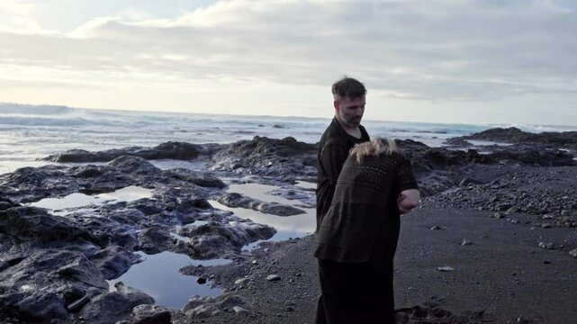 Passionate dancers performing bachata on volcanic beach