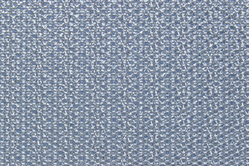 A surface of perforated metal filter of a cooker hood close up