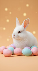 Fototapeta premium Adorable fluffy bunny sitting beside pastel colored easter eggs on a soft peach background, creating a charming holiday scene.