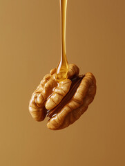 Oil dripping on walnut. Natural ingredient for cooking and skincare. Healthy fats and nutrition concept.