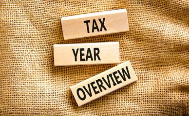 Tax year overview symbol. Concept words Tax year overview on beautiful wooden blocks. Beautiful canvas table canvas background. Business tax year overview concept. Copy space.