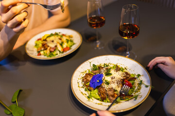 Couple dining together delicious looking food at their apartment.