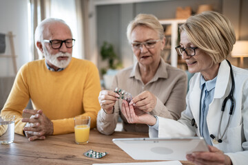 Doctor explaining medication to a senior couple