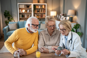 Doctor explaining medication to a senior couple