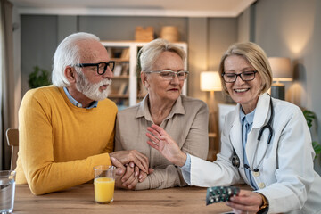 Doctor explaining medication to a senior couple