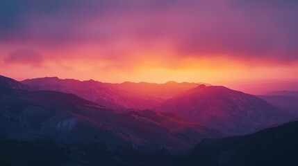 Fototapeta premium Vibrant sunset over majestic mountain range.