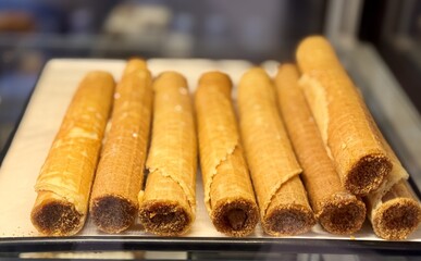 Treat yourself to our sweet waffles, which you can enjoy at any time of the day or night. An incredibly appetizing showcase with crispy, beautifully rolled waffles filled with delicious sweetness