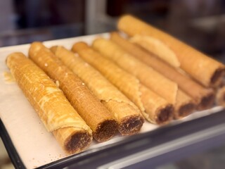 Treat yourself to our sweet waffles, which you can enjoy at any time of the day or night. An incredibly appetizing showcase with crispy, beautifully rolled waffles filled with delicious sweetness