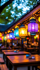 Fototapeta premium Colorful lanterns illuminating a patio at dusk