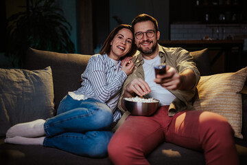 Happy couple enjoying movie night together