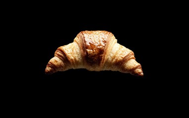 Golden Brown Glazed Croissant on Black Background