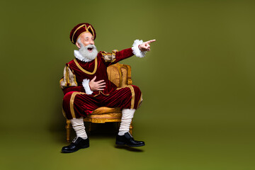 Elegant nobleman in historical costume seated on luxurious chair, pointing excitedly in cheerful...