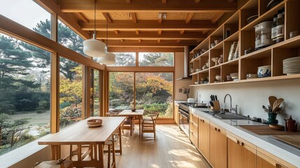 Fototapeta premium A modern kitchen overlooks a beautiful lush natural outdoor landscape