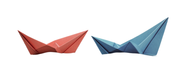 Red and blue origami boats facing each other, cut out