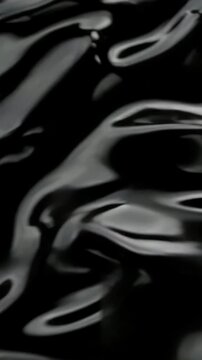 Mesmerizing black liquid waves create hypnotic abstract movement in elegant flowing pattern