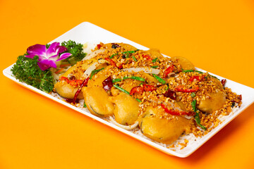 crispy Typhoon Shelter Eggplant served in plate isolated on orange background side view of hong...