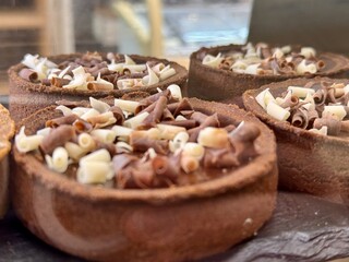Delicious and Decadent Chocolate Tartlets Adorned with Shavings for Ultimate Indulgence