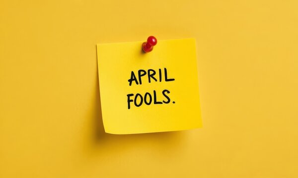 Yellow Sticky Note with April Fools Message Pinned on Yellow Wall