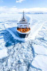 Expedition ship navigating through arctic ice floes (1)