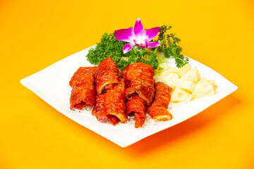 Crispy Fried Intestines Roll with rice and vegetable served in plate isolated on orange background side view of hong kong food