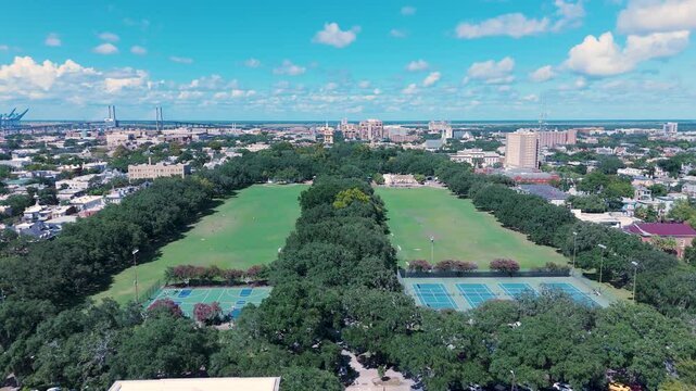 Sunny Afternoon Aerial View of Forsyth Park in Savannah Georgia. The city skyline and Talmadge Memorial Bridge can be seen in the background.