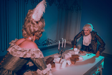 Baroque-themed couple engaging in a dramatic indoor performance