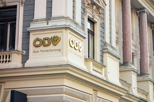 Golden logo of OBV (Osterreichische Beamtenversicherung) insurance company on historic building in Vienna, Austria