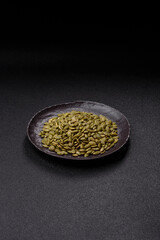 Peeled pumpkin seeds in a bowl, an ingredient for making vegetarian food