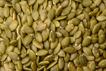 Peeled pumpkin seeds in a bowl, an ingredient for making vegetarian food