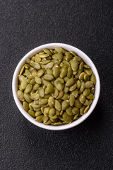 Peeled pumpkin seeds in a bowl, an ingredient for making vegetarian food