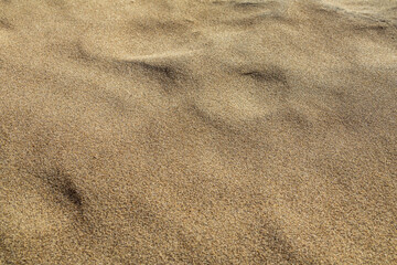 Close-up of sand textures and natural patterns, showcasing ripples, grains, and organic formations, perfect for background and texture