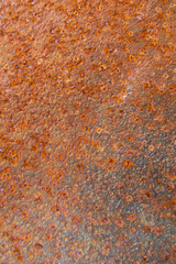 Close-up of rusted metal and weathered paint, featuring corrosion, peeling layers, and rough textures, perfect for background and texture